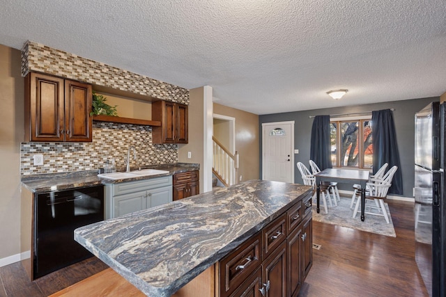 kitchen featuring dark wood-style floors, black appliances, open shelves, and a sink