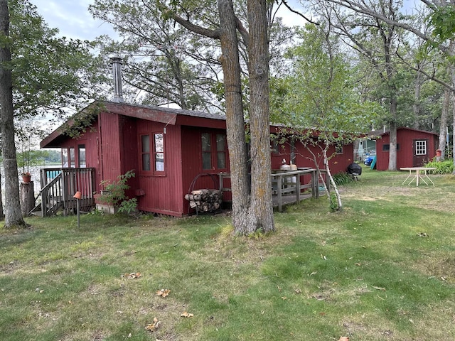 view of outbuilding featuring a lawn