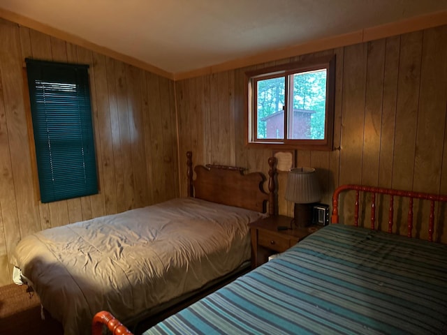 bedroom featuring wooden walls