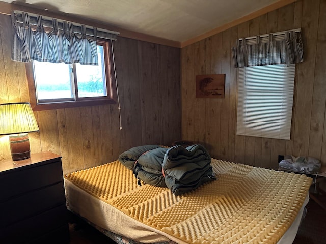 bedroom featuring wood walls