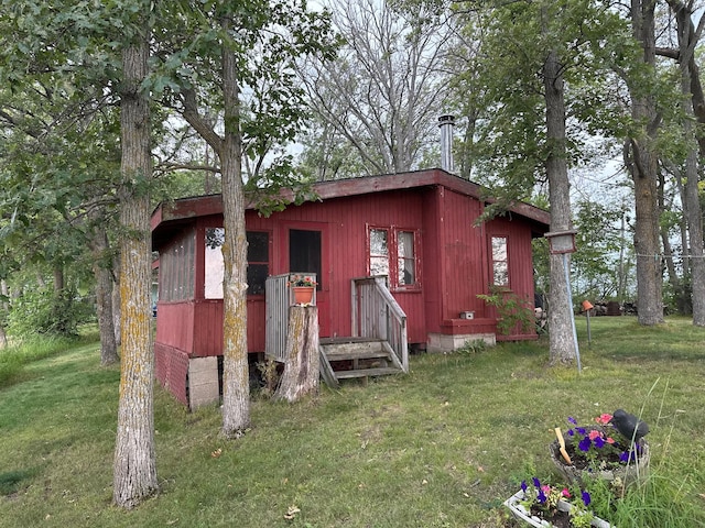 view of outdoor structure featuring a lawn