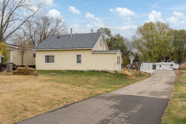 view of side of property with a yard