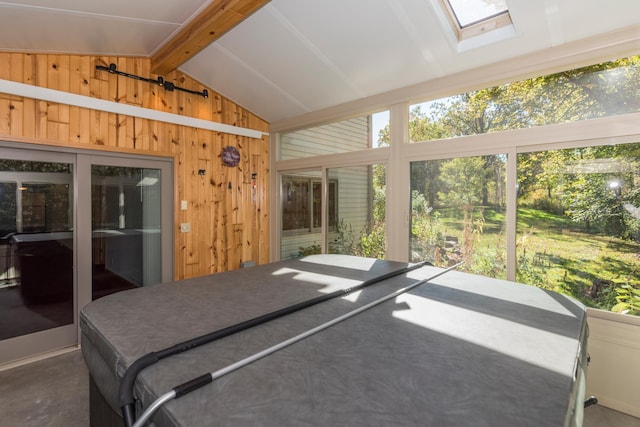 sunroom featuring vaulted ceiling with skylight