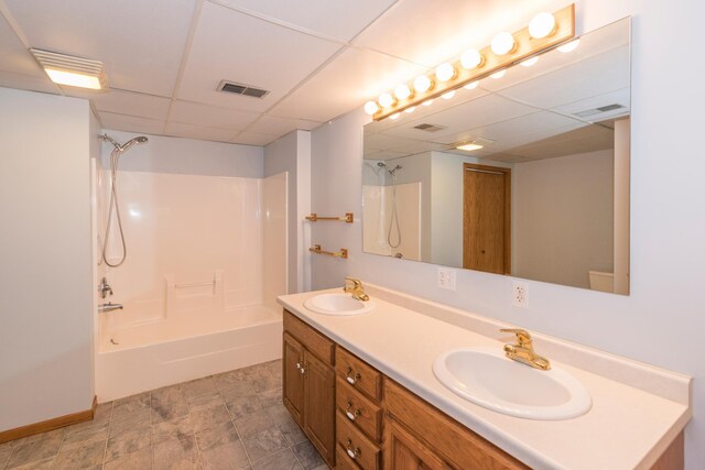 bathroom with washtub / shower combination, vanity, and a drop ceiling