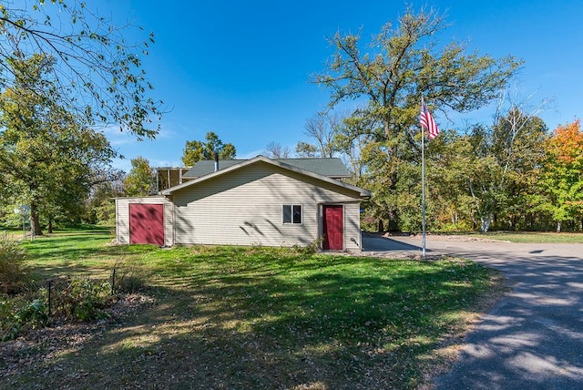 view of property exterior featuring a lawn