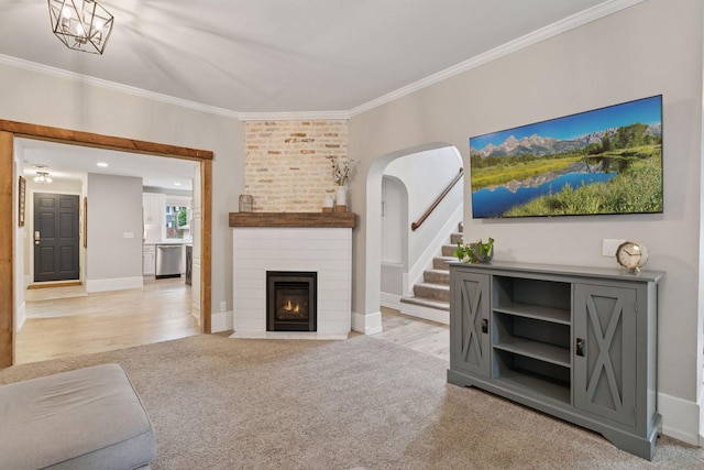 1989 Iglehart Ave, Saint Paul, MN 55104 - living area with crown molding, a large fireplace, stairs, baseboards, and light colored carpet