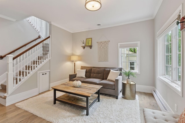 1989 Iglehart Ave, Saint Paul, MN 55104 - living room featuring baseboard heating, stairway, light wood-type flooring, crown molding, and baseboards