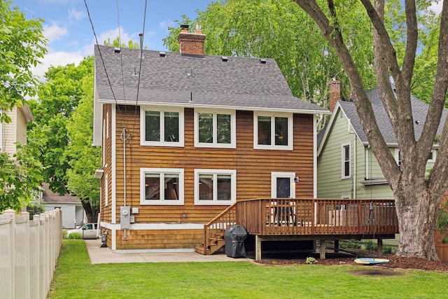 1989 Iglehart Ave, Saint Paul, MN 55104 - back of property with a chimney, a wooden deck, a patio, and a shingled roof