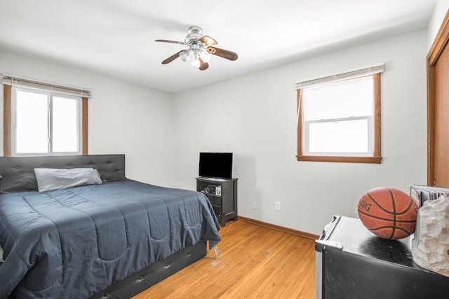 bedroom with ceiling fan and light hardwood / wood-style flooring