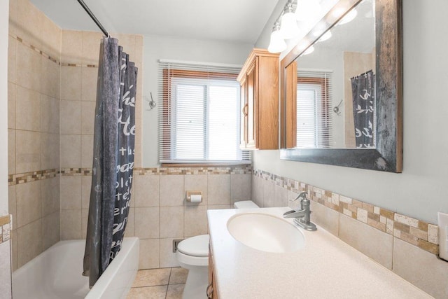 full bathroom with shower / tub combo with curtain, toilet, tile walls, vanity, and tile patterned flooring