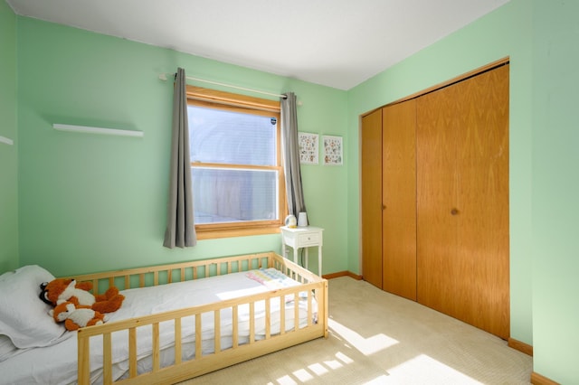 unfurnished bedroom featuring a closet, baseboards, and carpet