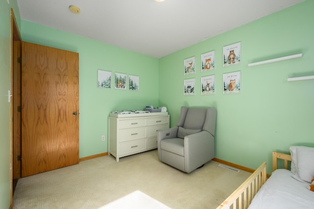 bedroom with visible vents, light colored carpet, and baseboards