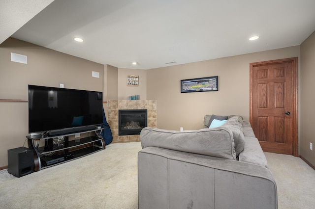 living area with recessed lighting, baseboards, carpet flooring, and a tile fireplace