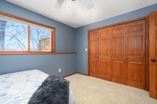 bedroom featuring carpet flooring, baseboards, a closet, and ceiling fan