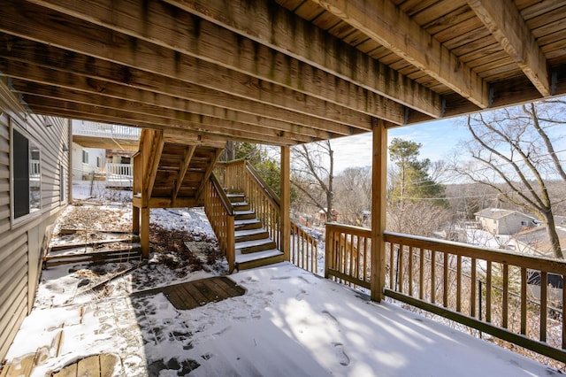 snow covered deck featuring stairway