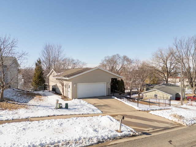 view of front of property with an attached garage, fence, and driveway