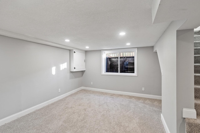 basement with carpet and a textured ceiling