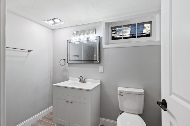 bathroom with vanity, wood-type flooring, and toilet