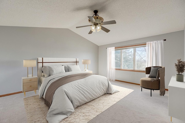 carpeted bedroom with lofted ceiling, ceiling fan, and a textured ceiling