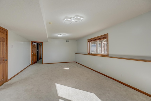 unfurnished room featuring light carpet