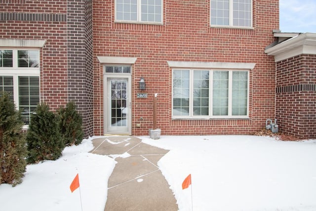 view of snow covered property entrance