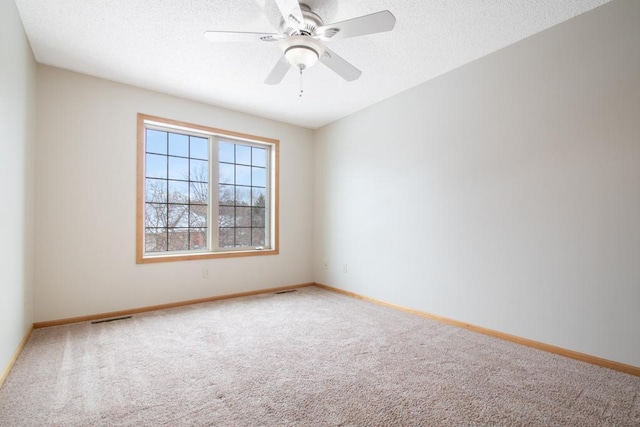 spare room with ceiling fan, carpet floors, and a textured ceiling