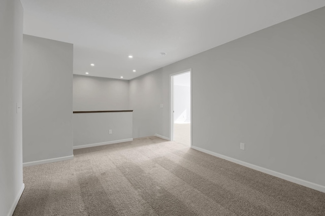 spare room featuring light carpet