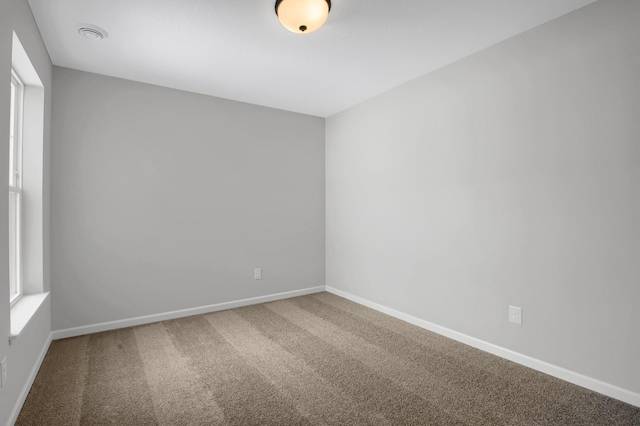 unfurnished room with carpet floors and plenty of natural light