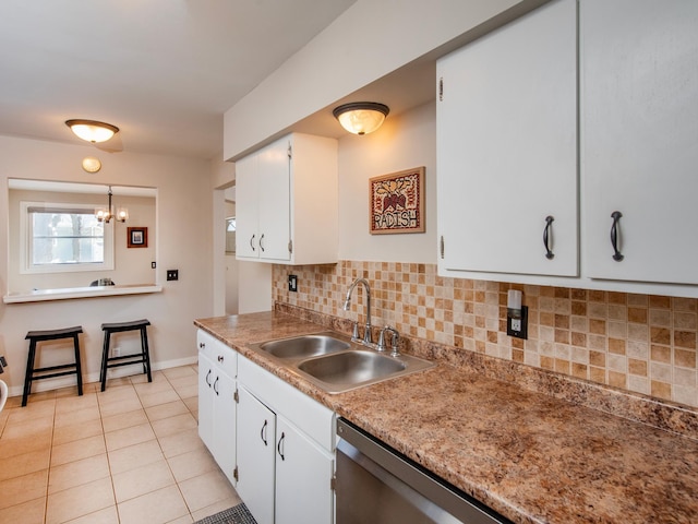 kitchen with white cabinetry, sink, decorative backsplash, and light tile patterned flooring