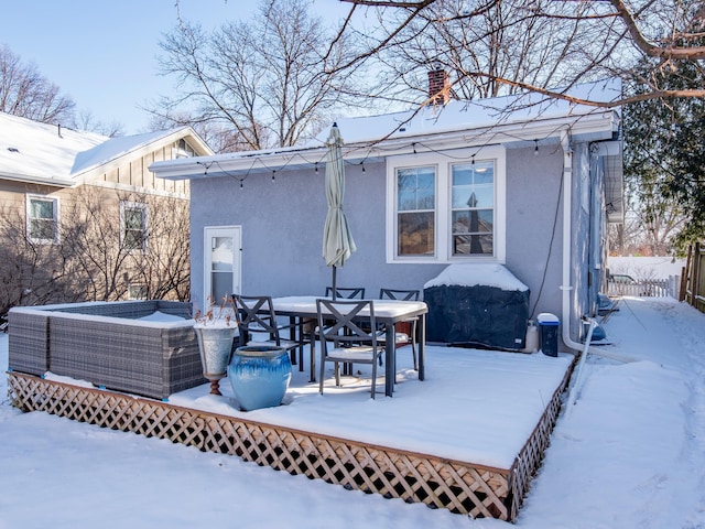 view of snow covered back of property