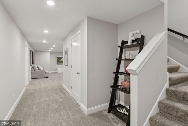 hall featuring recessed lighting, light colored carpet, and baseboards