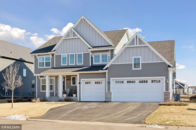 craftsman house with a garage, central air condition unit, and covered porch