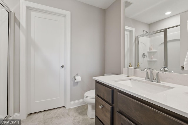 bathroom with toilet, visible vents, vanity, baseboards, and a stall shower