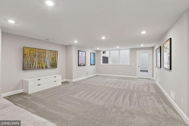 spare room featuring light carpet, visible vents, baseboards, and recessed lighting