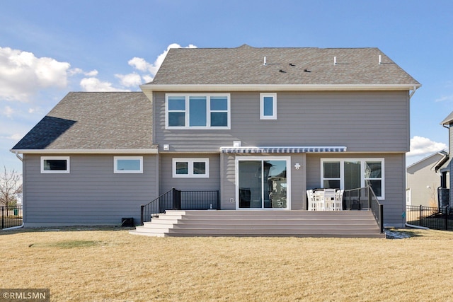 rear view of house with a wooden deck and a yard