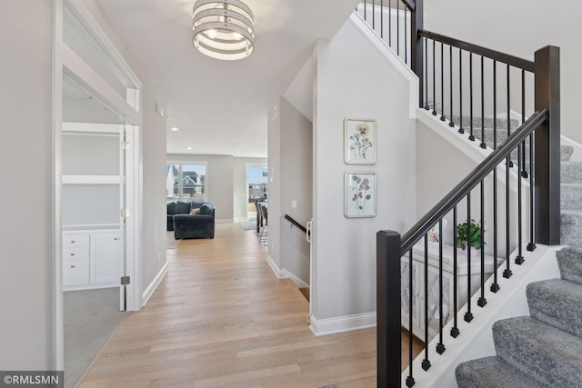 entrance foyer featuring light wood-type flooring and baseboards