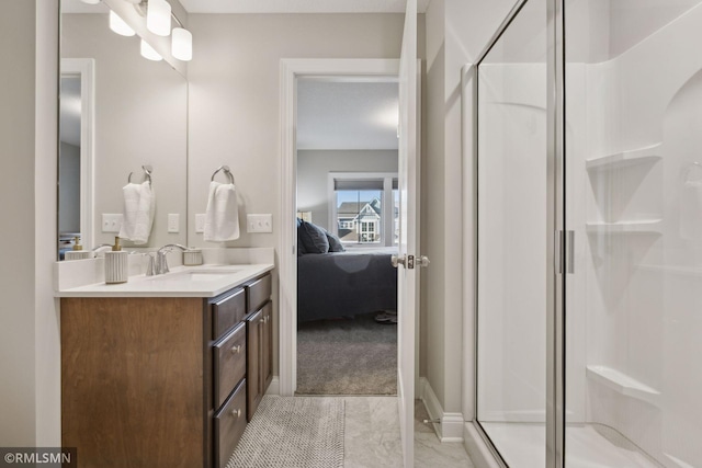 bathroom with ensuite bathroom, a shower stall, and vanity