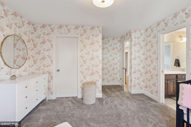 bathroom featuring wallpapered walls and vanity