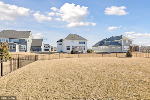 view of yard with a fenced backyard and a residential view