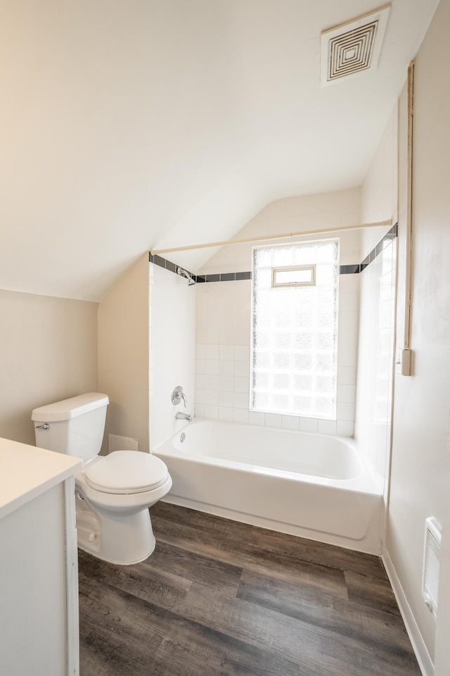 full bathroom featuring hardwood / wood-style flooring, vanity, and vaulted ceiling