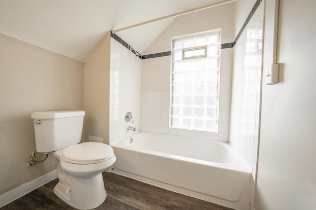 bathroom featuring lofted ceiling, toilet, tiled shower / bath combo, and hardwood / wood-style floors