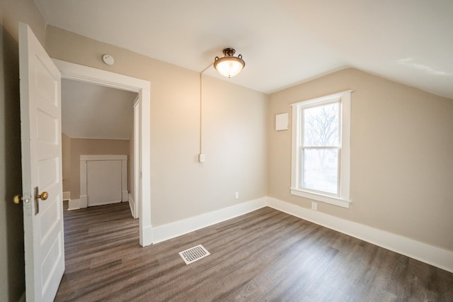 interior space featuring dark hardwood / wood-style floors and vaulted ceiling