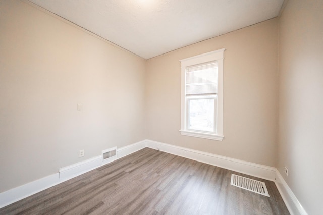 unfurnished room with hardwood / wood-style floors