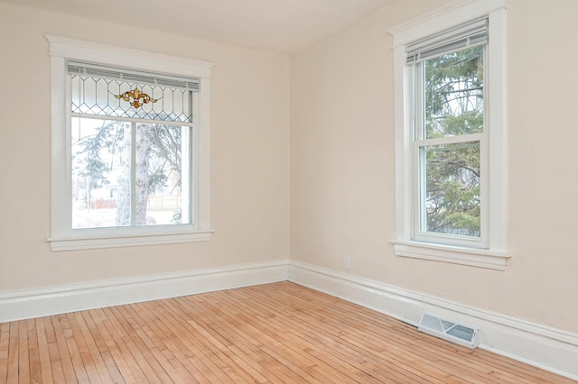 empty room with light hardwood / wood-style flooring