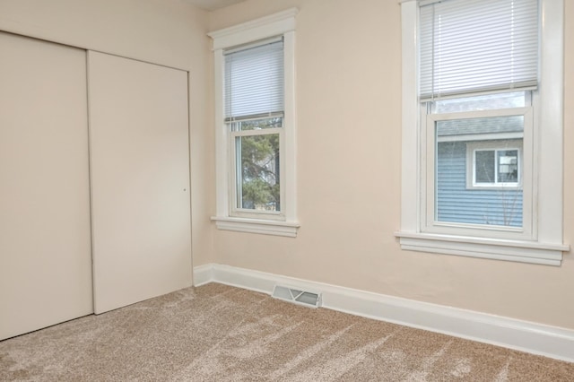 unfurnished bedroom featuring a closet and carpet flooring