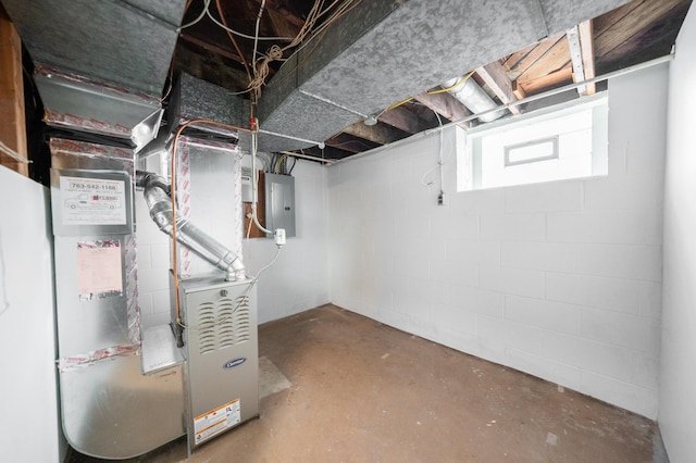 basement with electric panel and heating unit