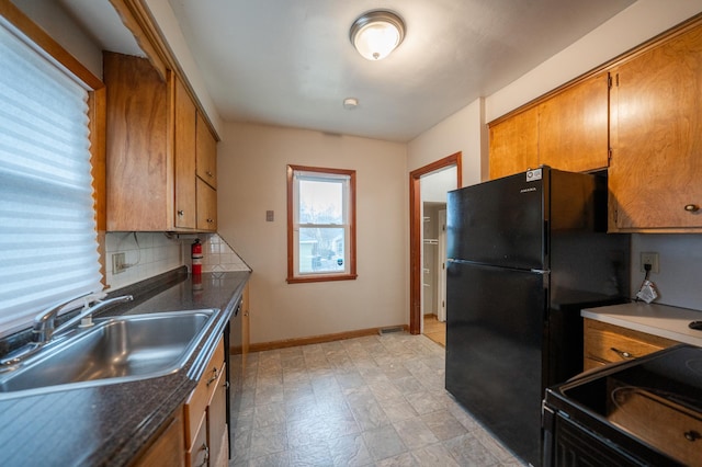 kitchen with sink, backsplash, and black appliances