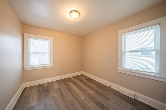 empty room with dark hardwood / wood-style floors