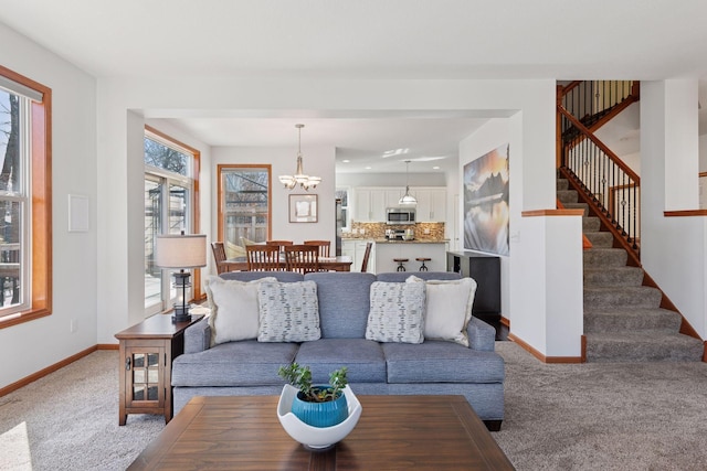 2536 Saunders Lake Dr, Minnetrista, MN 55364 - carpeted living area featuring baseboards, stairs, and a chandelier