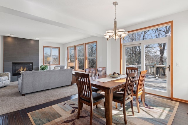 2536 Saunders Lake Dr, Minnetrista, MN 55364 - dining room with healthy amount of natural light, hardwood / wood-style floors, a chandelier, and a fireplace